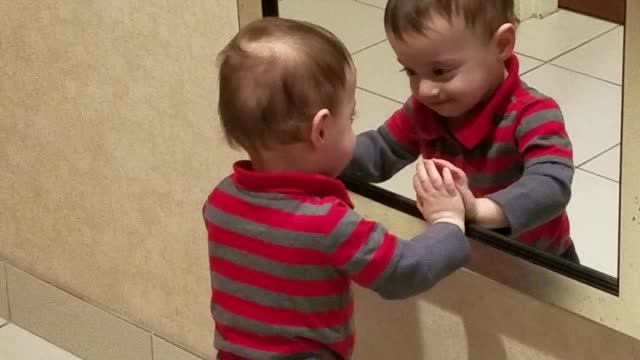 Boy Loves To Joke Around With His Reflection In The Mirror