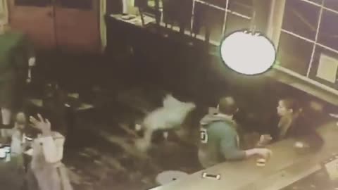 Security camera girls tumbles through bar doors onto face