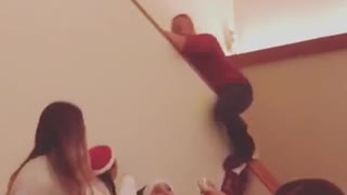 Man red shirt slides down stairs knocks down socks