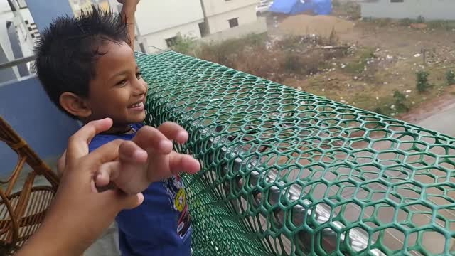 littel boy enjoying rain