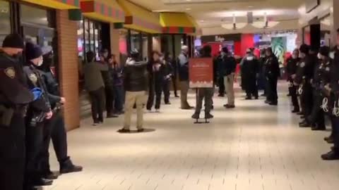 New York police officers detain people for violating the city's isolation rules and trying