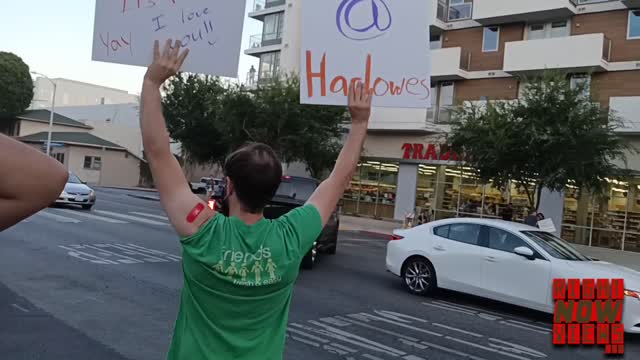 Man Flashes Jab At Anti-Vax Crowd