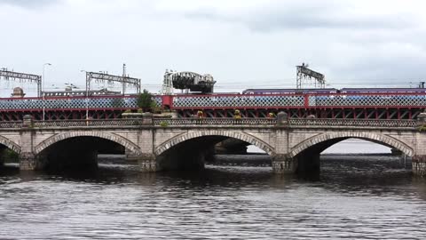 Photographer Under Bridge Taking Records Of Vehicles traveling over a bridge