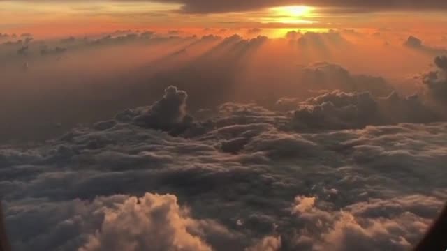 SUNSET SEEN OUTSIDE TO THE AEROPLANE