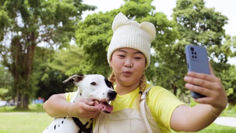 Woman taking selfies with dog