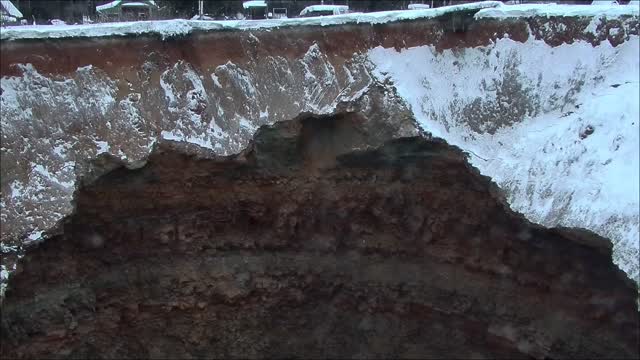 A huge hole in the ground on a flooded mine in Russia in the Urals city of Solikamsk