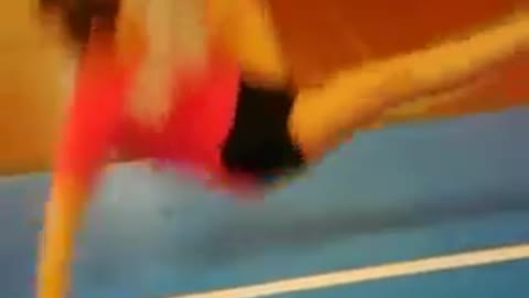 Cheer backflip blue mat red shirt