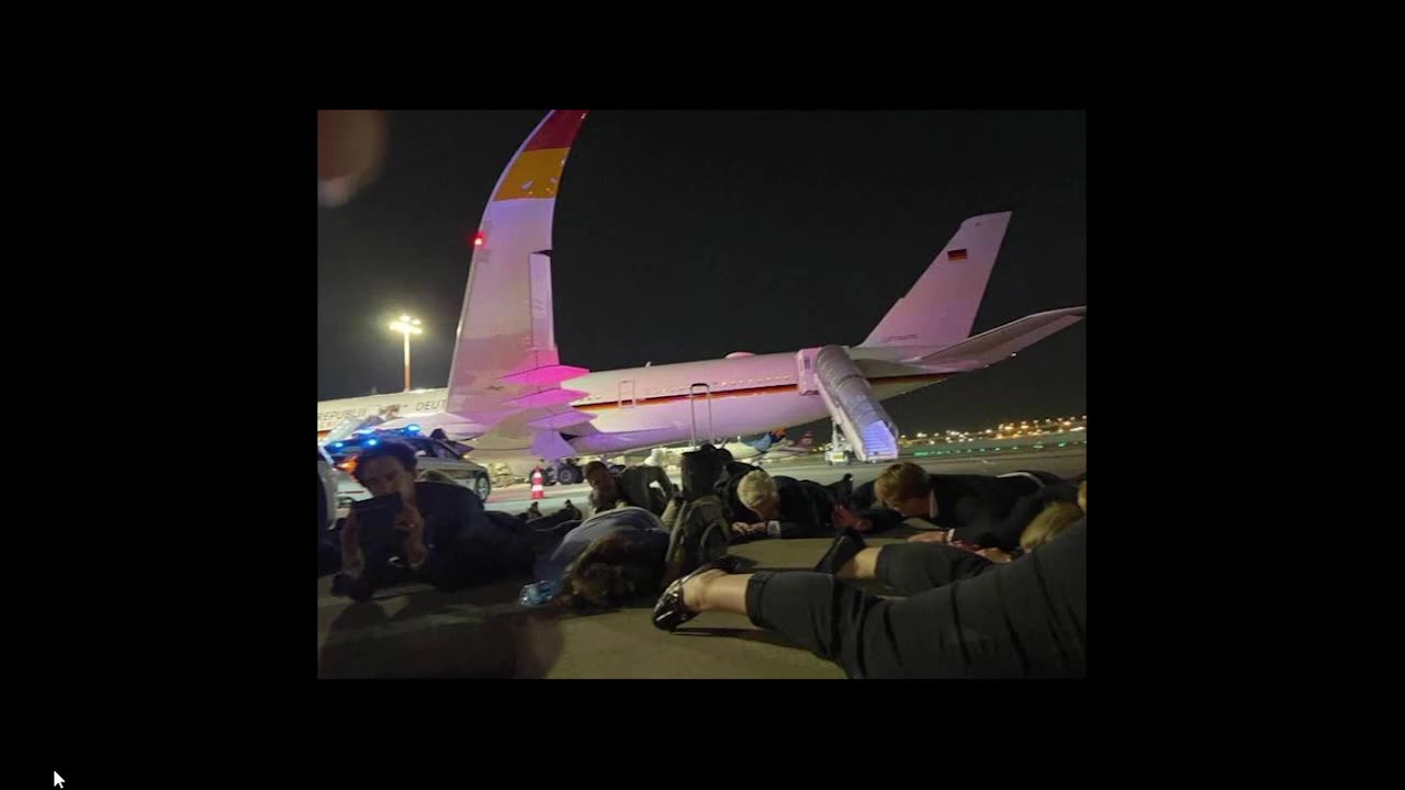 German Chancellor Scholz laying on runway after rockets were fired at the airport.