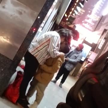 Couple makes out of the sidewalk, girl taller than guy