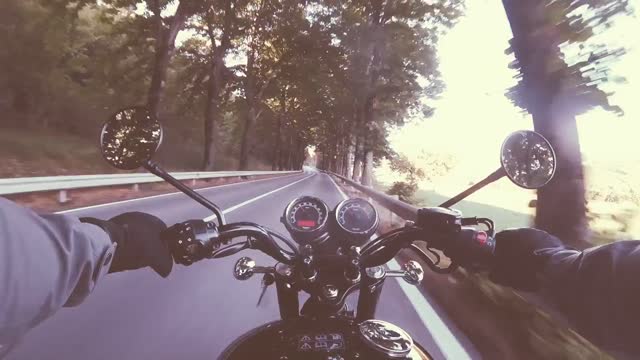 He is flying down the road on his motorcycle!