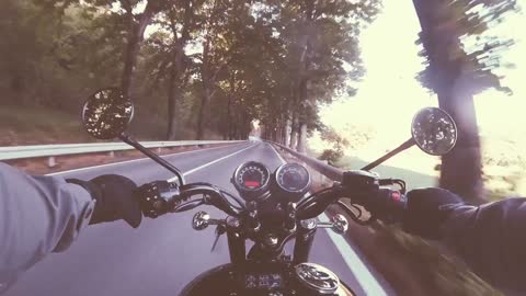 He is flying down the road on his motorcycle!