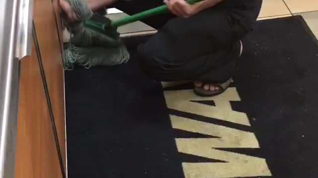 Fast Food Worker Uses Mop to Clean Benches