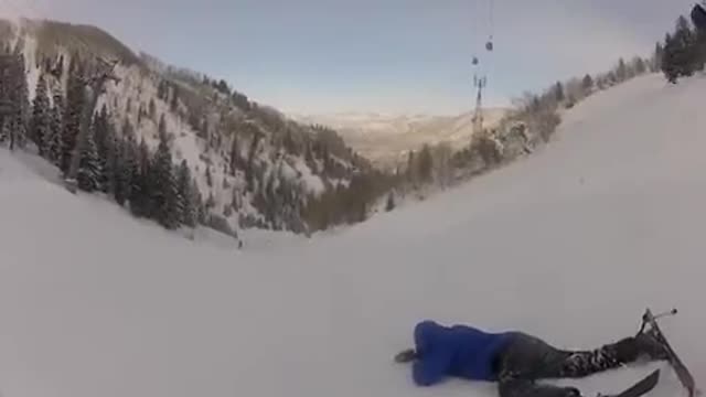 Yellow and blue crisscrossing skiers crash together on snow