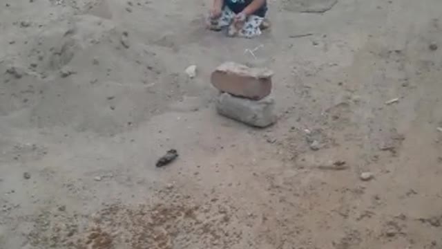 Babyboy Playing With Sand