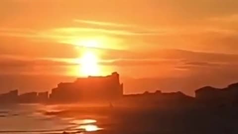 Why does the sun appear to be in front of some of the clouds shown in this video_