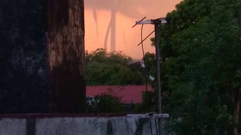 Multiple Waterspouts Wind Down From Sky During Storm