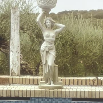 A wonderful statue of a woman holding a bowl above her head