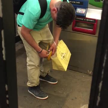 Blue shirt yellow bag falls asleep standing up