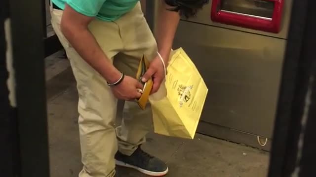 Blue shirt yellow bag falls asleep standing up