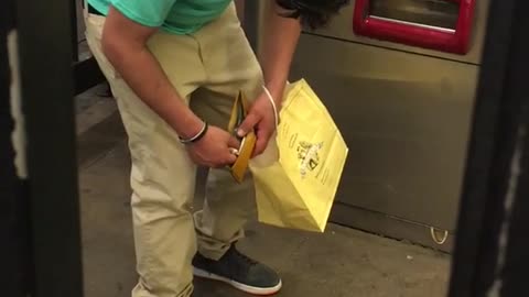 Blue shirt yellow bag falls asleep standing up