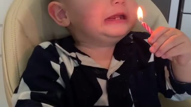 Very funny boy singing and blowing out candles