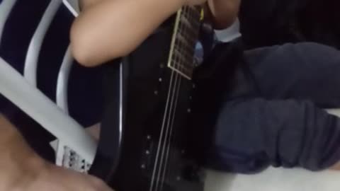 Child Learning Guitar