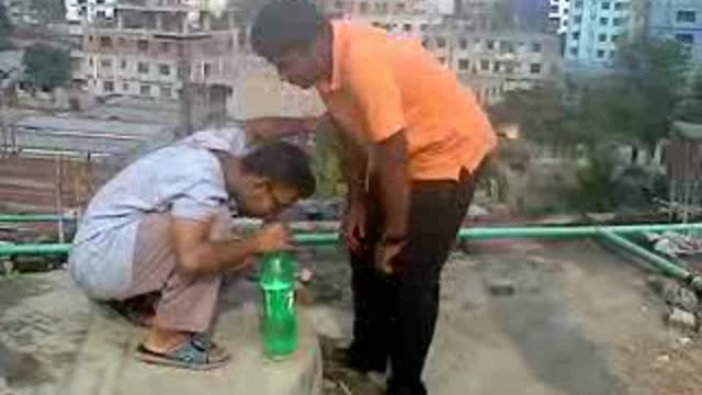 Orange shirt guy on roof top gets sprite bottle magic trick in eye