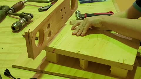 Caleb making a wooden sled