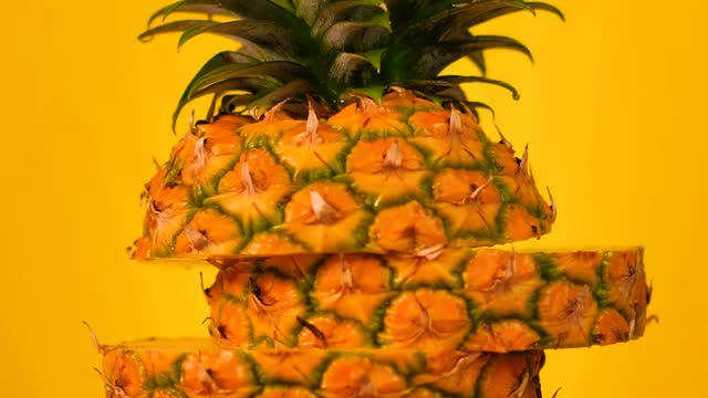 Pineapple sliced on a yellow background