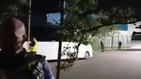 Irish police officers force locals to take in a number of busses with additional illegal migrants
