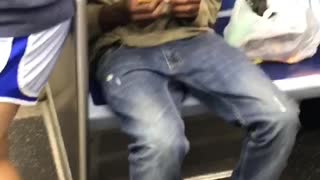 Guy blue shoes green shirt rolling blunt subway