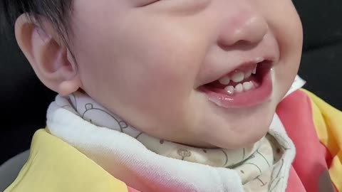 baby laughing while eating