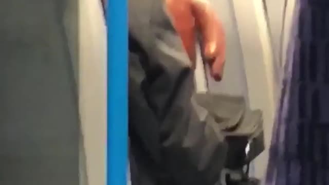 Person with orange brown monster on train