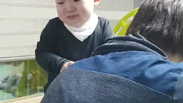 This is a video of a baby trying to catch his father and poop.