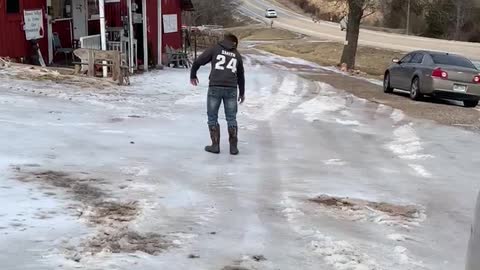 Watch my grandson try to walk up the hill on the ice.