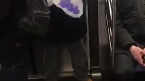 Man holds skull of sabertooth tiger on subway train