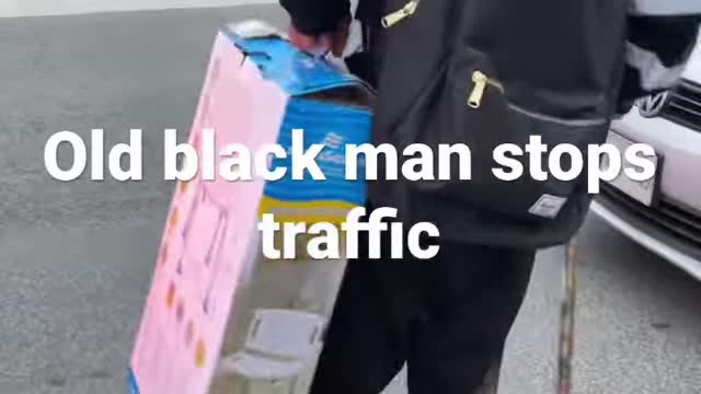 old black man stops traffic