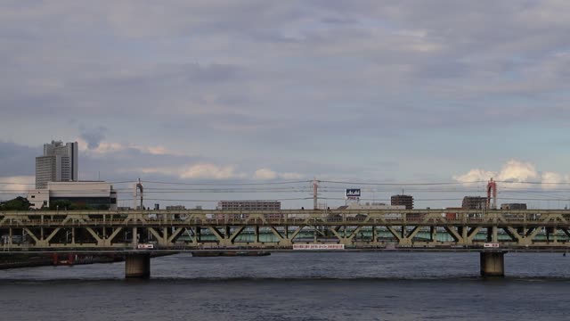 Train Passing Over a River Bridge