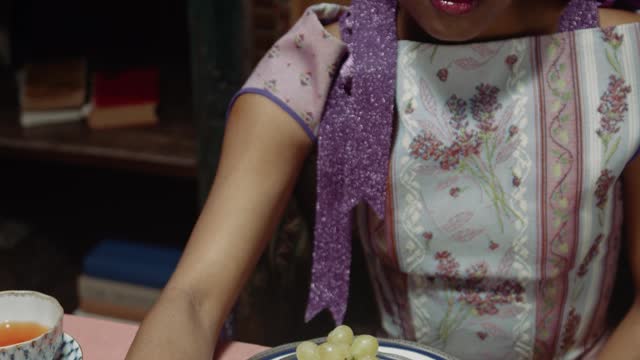 A Woman Eating Grapes With Her Cat On The Table--FH