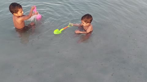 Cute little boys beach bath