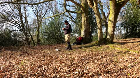 Packing gear away on a ironage hillfort. New forest.