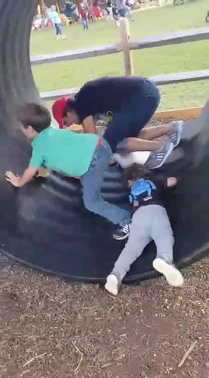 Mom And Young Sons Take A Walk In A Giant Hamster Wheel