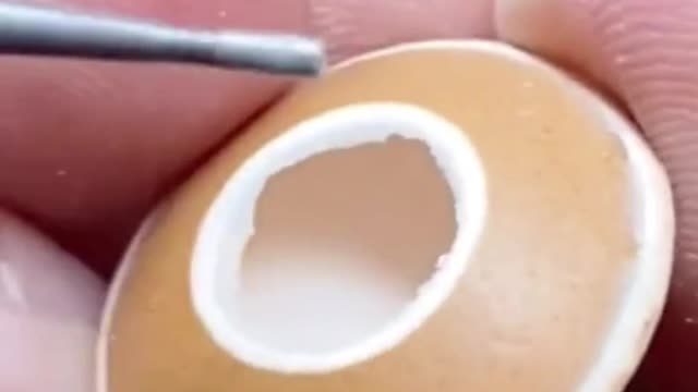 Carving on an egg shell takes patience