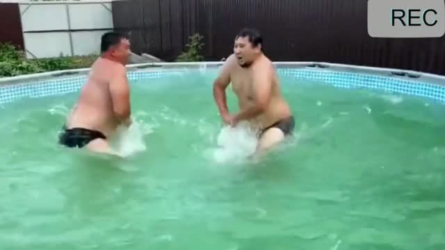 The fun of two guys, playing in the pool. You like that?