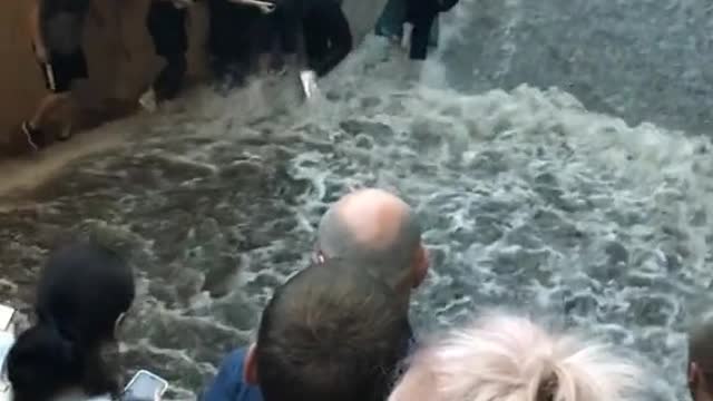 Passengers Flee as Flooding Flows Down Metro Stairs