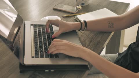 Hands of a girl working on a computer