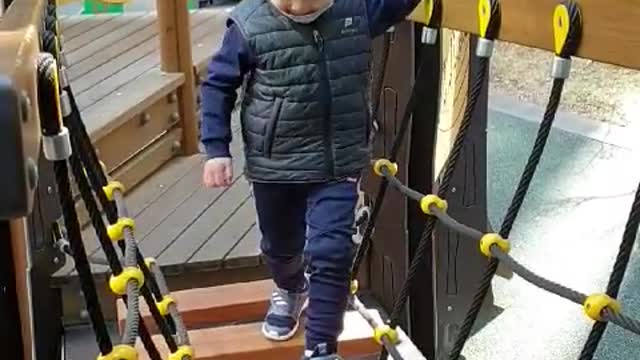 This is a video of a baby playing happily on the playground.