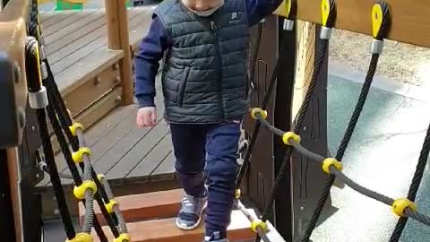 This is a video of a baby playing happily on the playground.