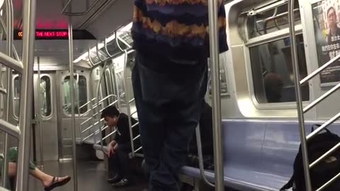 Man in orange purple and black jacket pull ups on train