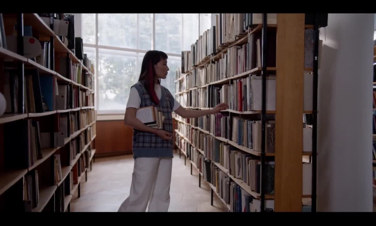 Woman Searching Books in a Library